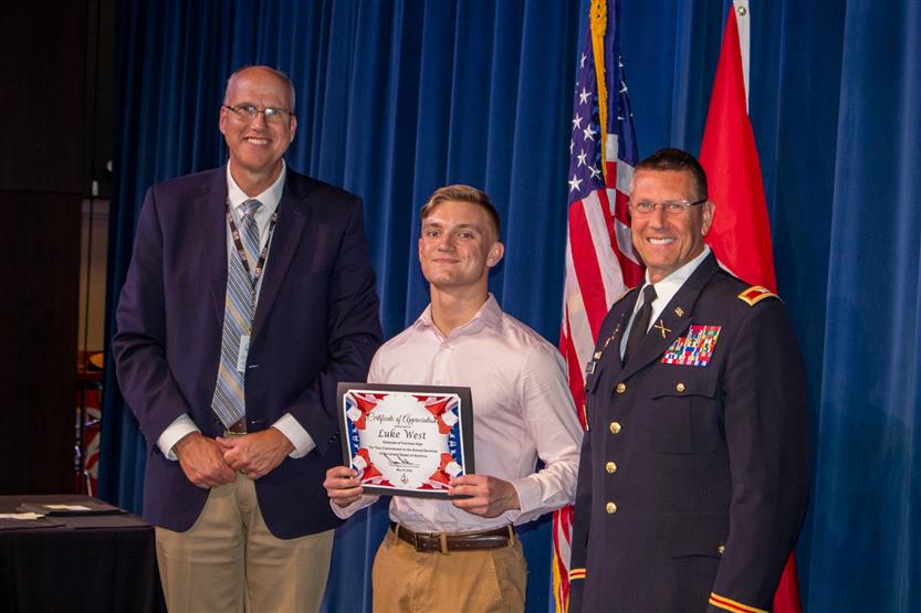 A student is honored for serving in the US Armed Forces after high school